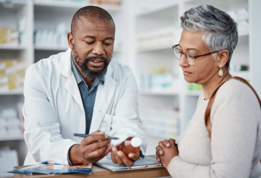 pharmacist helping in local pharmacy