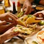 friends-eating-tacos-in-Mexican-restaurant